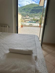 a white bed with a towel on top of it at Relais holiday in Sorrento