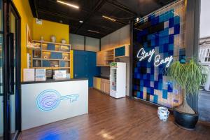 a store with a refrigerator and a counter in a room at Patong Poshtel in Patong Beach