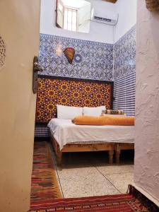 Una cama o camas en una habitación de Dar Berrada-Ziat