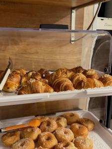 a display case of pastries and donuts in a bakery at Chiaia Suites in Naples
