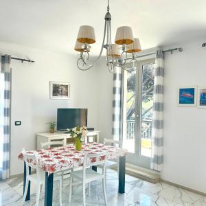 a dining room with a table and a tv at Villa sur mer, chez Angelina in Grimaud +20 photos