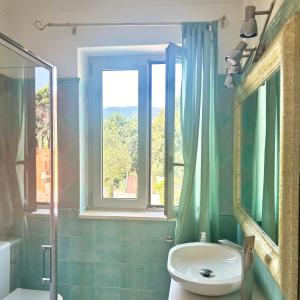 a bathroom with a sink and a window at Villa sur mer, chez Angelina in Grimaud