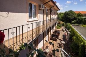 a balcony of a house with chairs and a patio at City Center Studio with Garden in Piešťany
