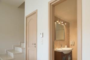 a bathroom with a sink and a mirror at Nere Suites in Lygaria +62 photos