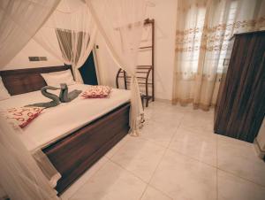 a bedroom with a bed with a canopy at Canopy villas in Mirissa