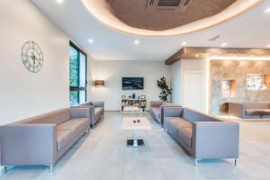 a waiting room with couches and a table at Adriatico Family Village in Gatteo a Mare