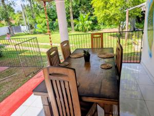 a wooden table and chairs on a porch at Canopy villas in Mirissa