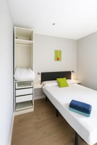 a bedroom with two beds and a small closet at Nuñez de Arce in Toledo