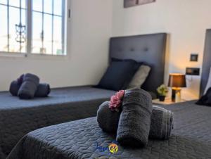 a bedroom with two beds and a stuffed animal on a bed at Contemporary 2 Bed Apartment with Com Pool VM77 in Villacosta +5 photos