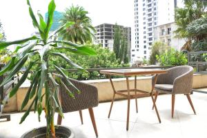 a table and two chairs and a plant on a balcony at Sun View Hotel in Addis Ababa