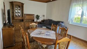 a living room with a table and a couch at Apartmenthaus-Winkler Wiener Neustadt Umgebung 