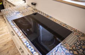 a stove top oven in a counter in a kitchen at ZumSchutzpatron in Bschlabs +51 photos