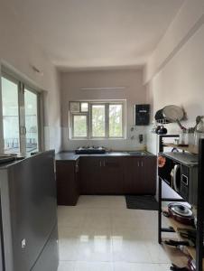 a kitchen with a stainless steel refrigerator and a sink at Modern 2BHK Hideout in Benaulim in Benaulim