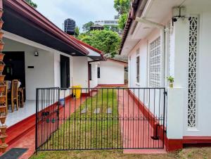 a balcony of a house with a red fence at Canopy villas in Mirissa