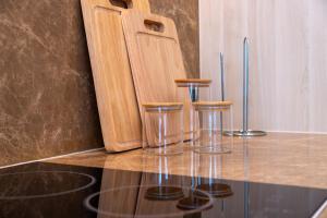 a counter with three bar stools on top of it at Bangtao Golf View Apartments in Laguna Phuket +17 photos