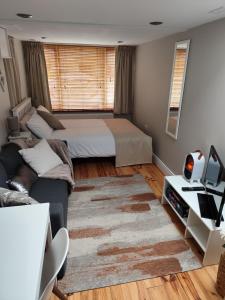 a bedroom with two beds and a couch at Amy's Suite in Killarney +15 photos