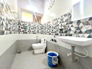 a bathroom with a sink and a toilet at QUEENS COTTAGE - individual cottage in Ooty +35 photos