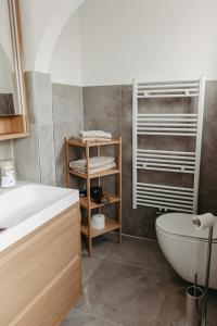 a bathroom with a sink and a toilet and a tub at Ferienwohnung Maria in Herten