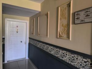 a hallway with a white door and pictures on the wall at Hannapart Otel in Egirdir +50 photos