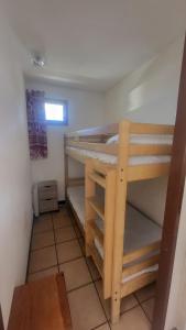 a bedroom with two bunk beds in a room at Nice studio near the ski lift in Briançon