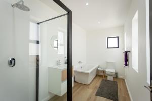 een badkamer met een bad, een toilet en een wastafel bij Serenity on Sidwell in George +82 foto's