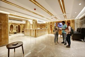 a group of people standing in a hotel lobby at The Vanson Pride in New Delhi