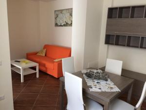 a living room with a table and a couch at Affittacamera La Dormiente in Torrecuso