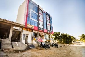 a building with motorcycles parked in front of it at Hotel O Prayag in Jaipur