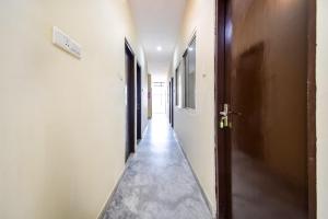 an empty corridor with a door at Hotel O Prayag in Jaipur
