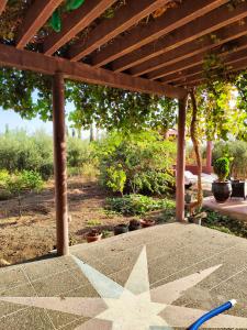 a star on a patio under a wooden pergola at La Novia Marrakech in Tahannout