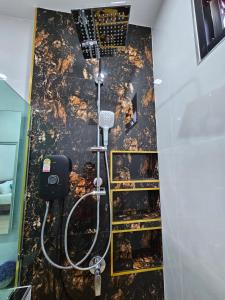 a bathroom with a shower with a black wall at Chalalai Villa Private Pool Ao Nang Krabi in Ao Nam Mao