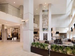 a lobby of a hotel with tables and chairs at Swissotel Chicago in Chicago