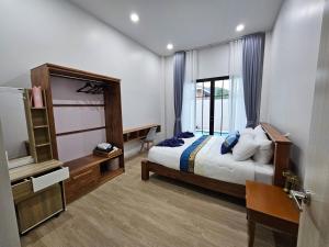 a bedroom with a bed and a desk and a window at Chalalai Villa Private Pool Ao Nang Krabi in Ao Nam Mao +48 photos