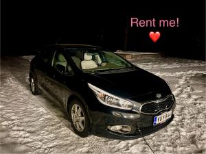 a black car parked in the snow with a red heart at Cosy Station Homestay in Rovaniemi