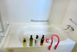a bath tub with three bottles in it at Asahikawa - house / Vacation STAY 5789 in Higashikagura +18 photos
