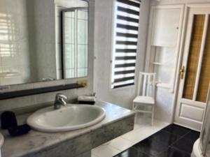 a bathroom with a sink and a mirror at Villa Los Ojos in Charco del Palo +16 photos