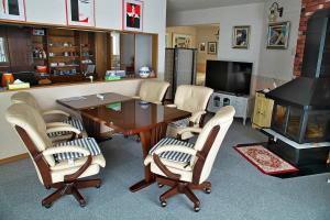 a living room with a table and chairs and a television at Asahikawa - house / Vacation STAY 5789 in Higashikagura