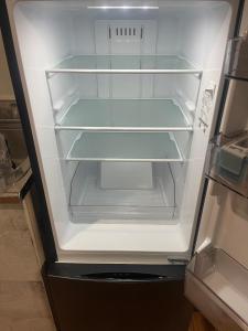 an empty refrigerator with its door open in a kitchen at コーポ川端 in Goshogawara