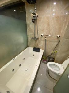 a bathroom with a white toilet and a shower at DN property in Bandung