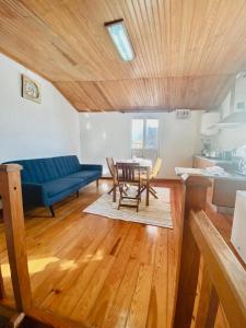 a living room with a blue couch and a table at Apartment in Coimbra Historical Center in Coimbra