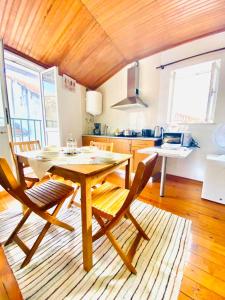 a kitchen with a wooden table and chairs in a room at Apartment in Coimbra Historical Center in Coimbra