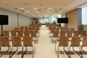 a conference room with chairs and a podium at ME Lisbon by Meliá in Lisbon +61 photos