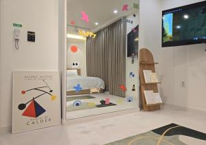 a room with a bedroom with a bed and a tv at 라메르스테이&수원파티루프탑 in Suwon
