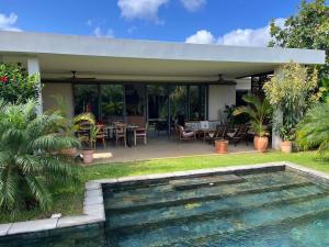 a house with a swimming pool and a patio at Belle Villa de Grand Baie in Midlands Station