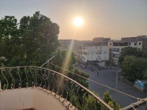 a view from a balcony of a city with the sun setting at Adream partment in Luxor in Luxor +5 photos