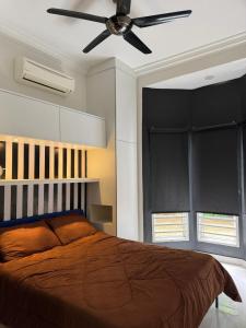 a bedroom with a bed and a ceiling fan at Micasa Bagan Laland,halal only in Tanjong Sepat +47 photos