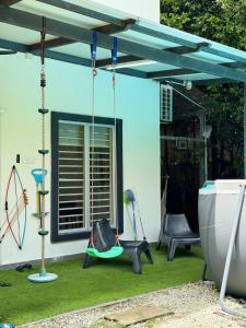 a pergola with a swing in a yard at Micasa Bagan Laland,halal only in Tanjong Sepat