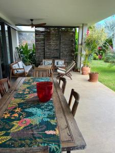 a wooden table with a bowl on top of a patio at Belle Villa de Grand Baie in Midlands Station