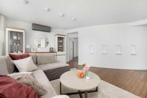 a living room with a couch and a table at Family Apartment with 3 Bedrooms & Air Conditioning in the Centre of Wrocław by Noclegi Renters in Wrocław