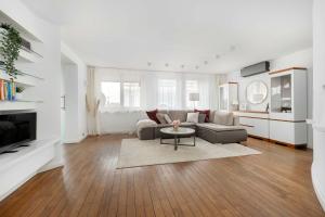 a living room with a couch and a table at Family Apartment with 3 Bedrooms & Air Conditioning in the Centre of Wrocław by Noclegi Renters in Wrocław